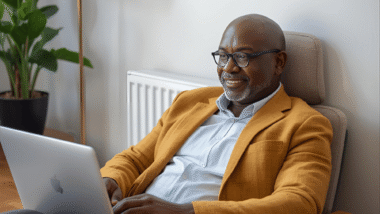 50+ gentleman comfortably working on his laptop from home